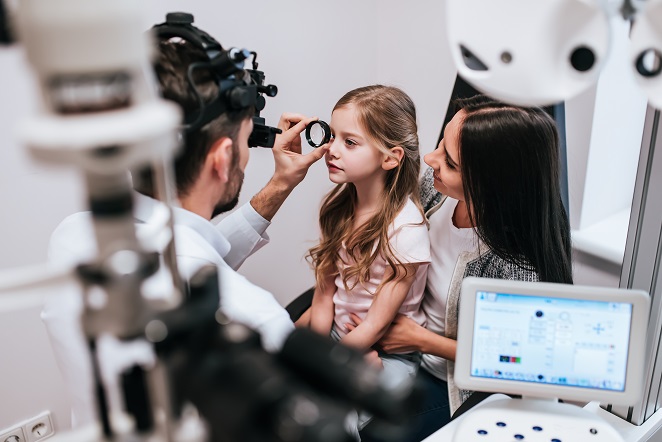Girl in chair getting Eye Exam